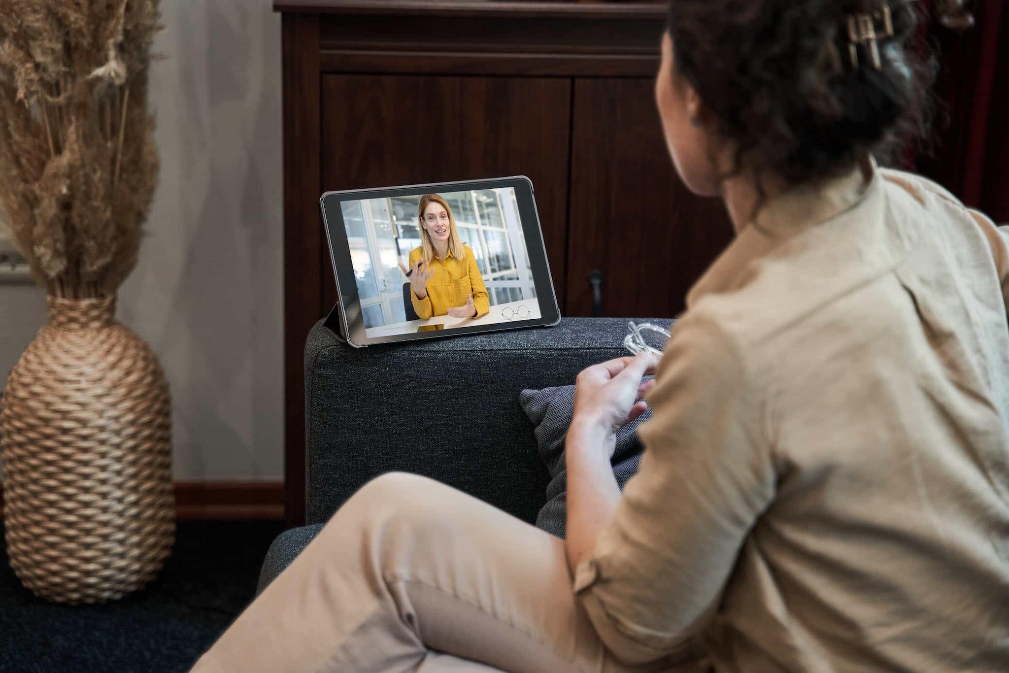 Woman on video call discusses ghostwriting project with client remotely.